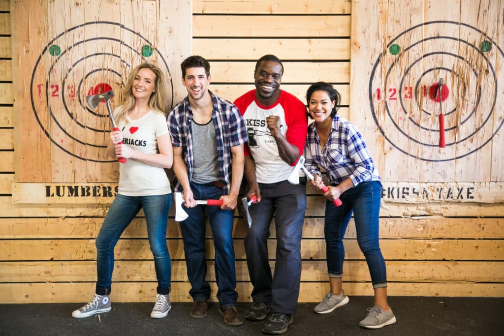 Group posing for axe throwing experience photo